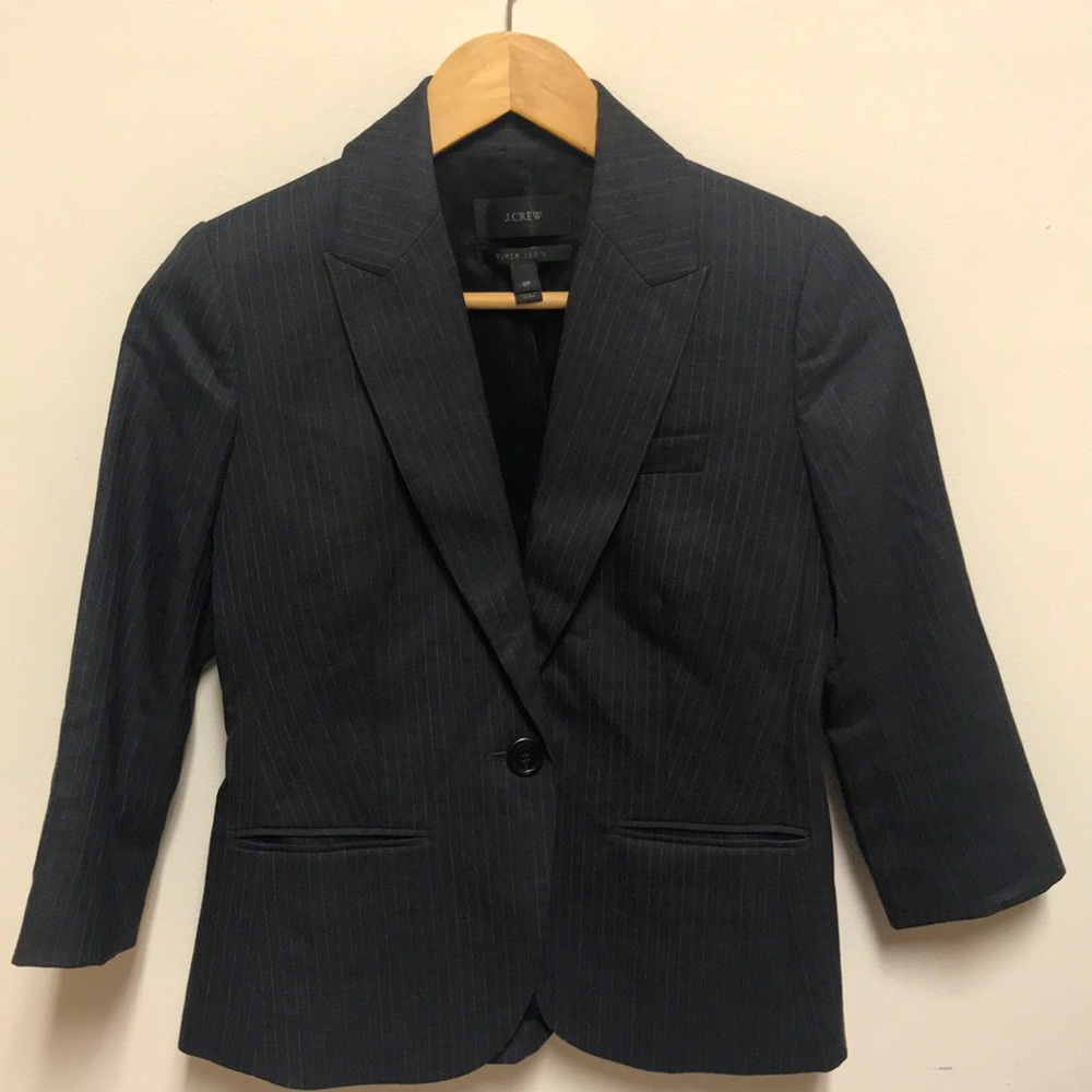 Dark grey pinstriped city fit suit .